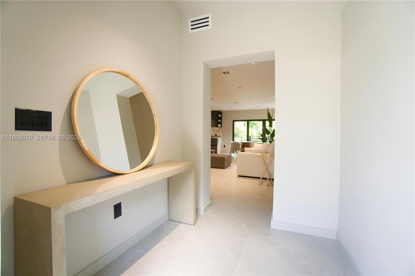 2155 Southwest 25th Terrace Miami, FL 33133 - Photo 5 of 20 an entryway with a table and a mirror
