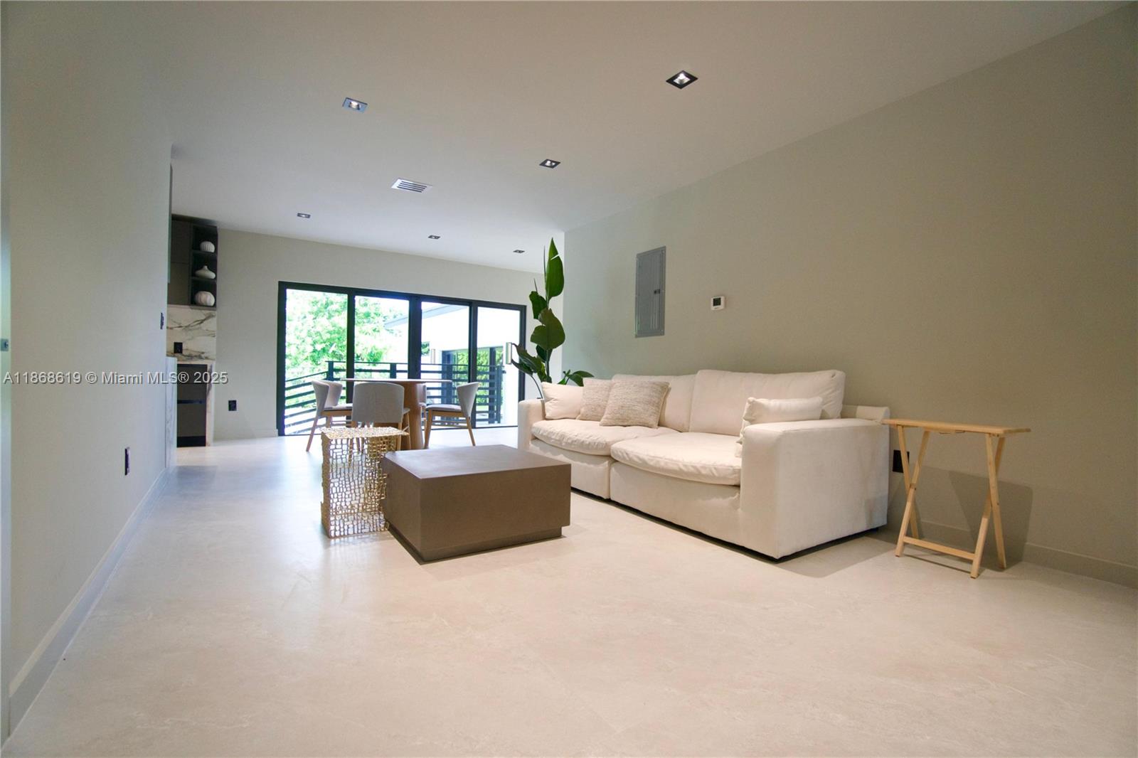 2155 Southwest 25th Terrace Miami, FL 33133 - Photo 6 of 20 a living room with furniture and a large window