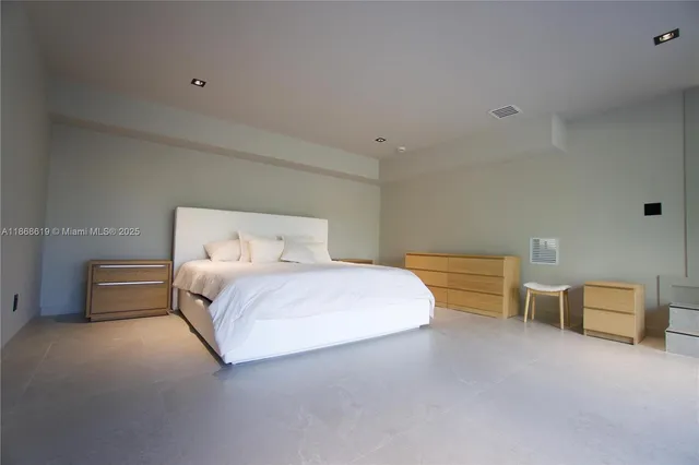 a bedroom with a bed and lamp