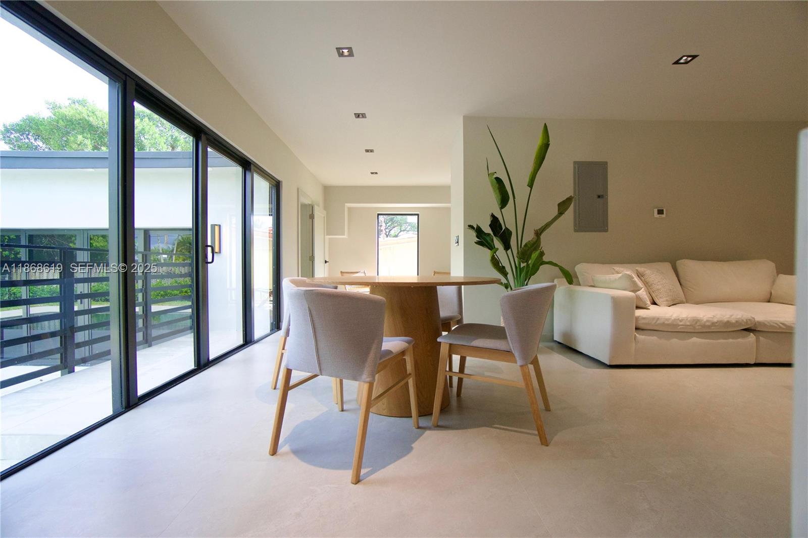 2155 Southwest 25th Terrace Miami, FL 33133 - Photo 9 of 20 a living room with furniture a wooden floor and a large window