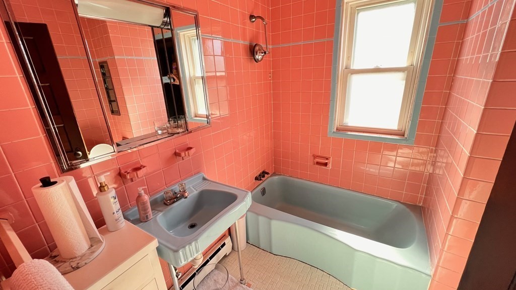 14 Sargent Street Winthrop, MA 02152 - Photo 12 of 17 a bathroom with a sink a toilet a tub and shower