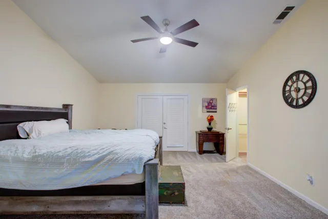 a bedroom with a large bed and a chandelier