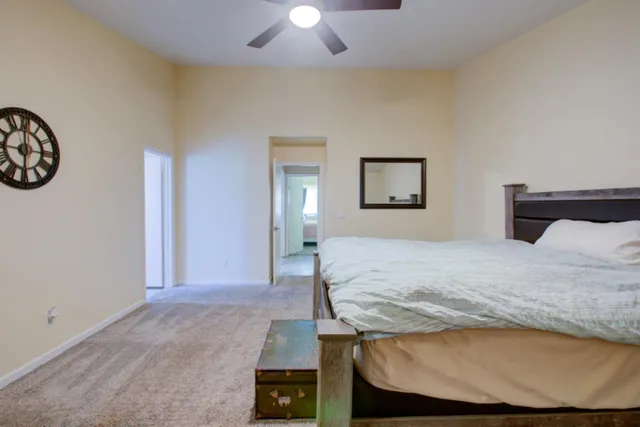 a bedroom with a bed and a chandelier