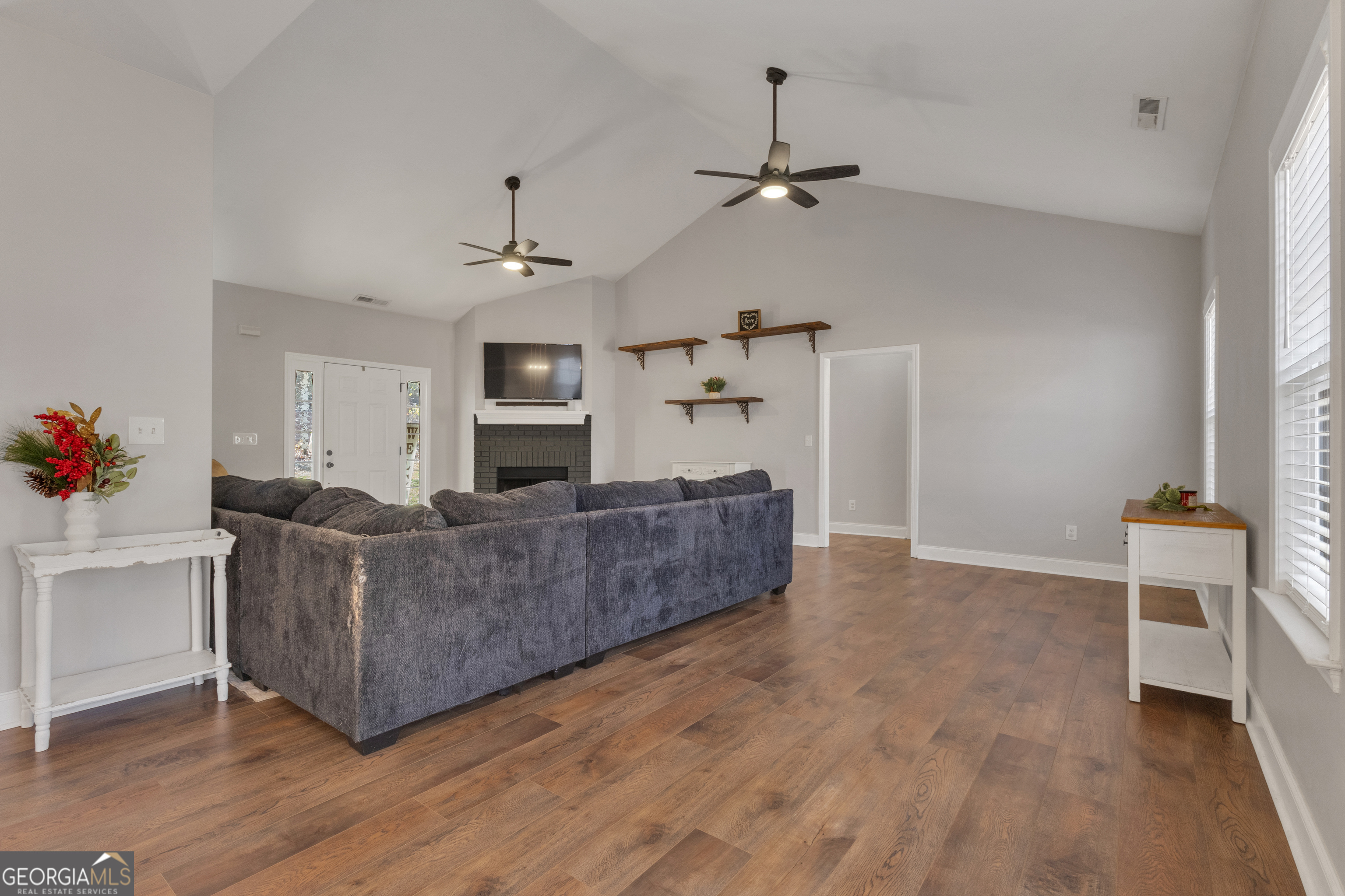 1135 Baptist Camp Road Griffin, GA 30223 - Photo 11 of 54 a living room with furniture and a fireplace