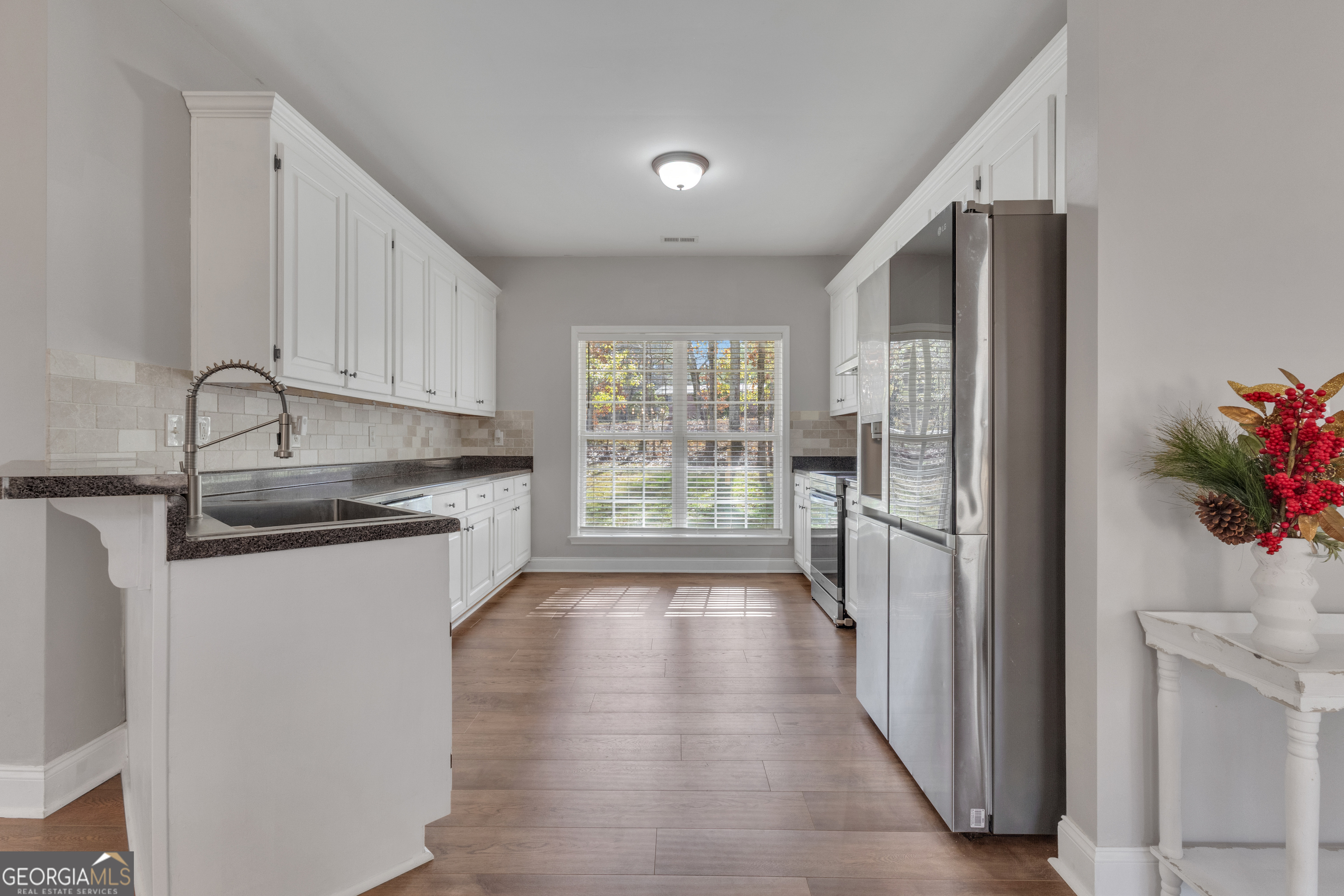 1135 Baptist Camp Road Griffin, GA 30223 - Photo 15 of 54 a kitchen with stainless steel appliances granite countertop a refrigerator and a sink