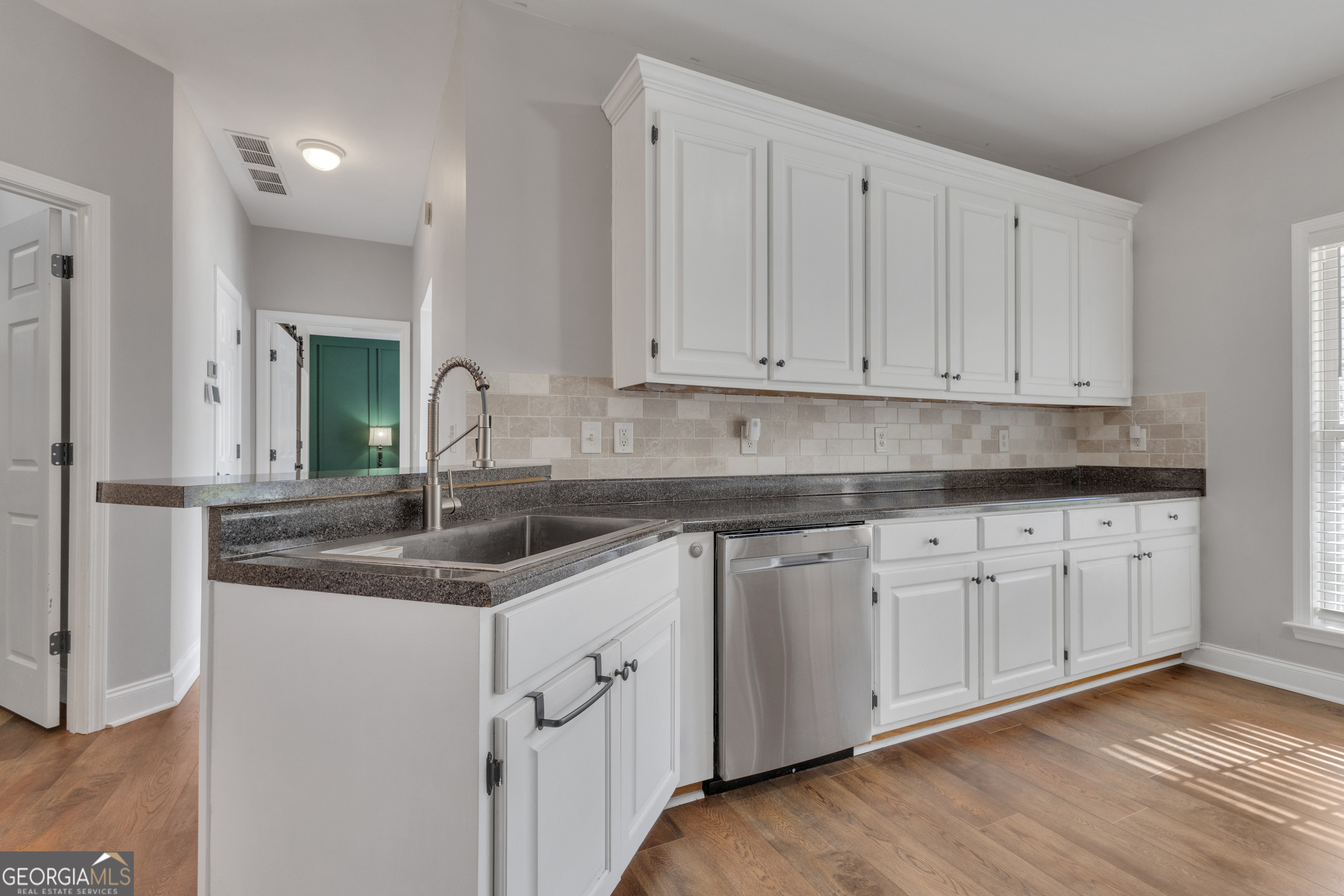 1135 Baptist Camp Road Griffin, GA 30223 - Photo 16 of 54 a kitchen with granite countertop white cabinets and a sink