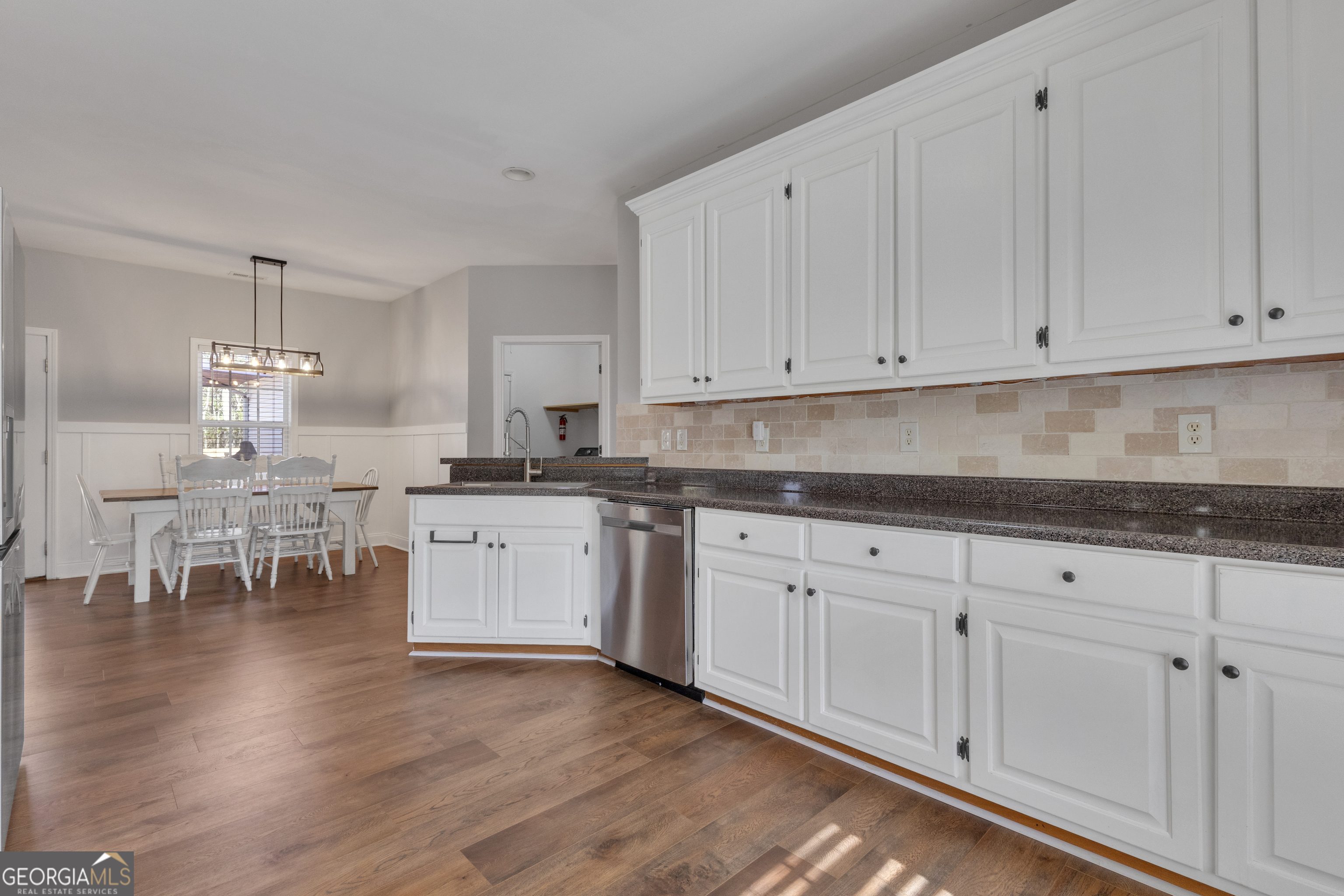 1135 Baptist Camp Road Griffin, GA 30223 - Photo 18 of 54 a kitchen with granite countertop white cabinets and white appliances