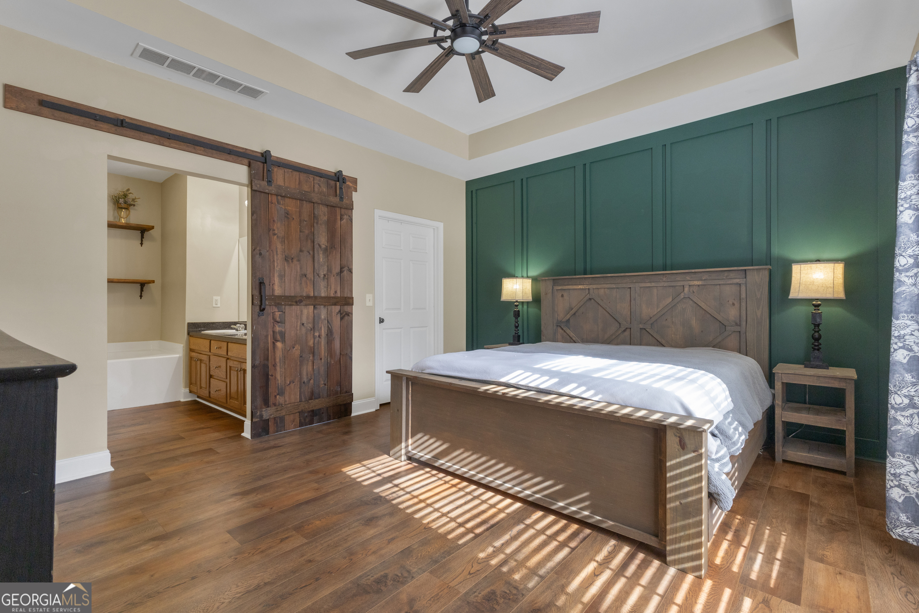 1135 Baptist Camp Road Griffin, GA 30223 - Photo 25 of 54 a bedroom with a bed and a chandelier