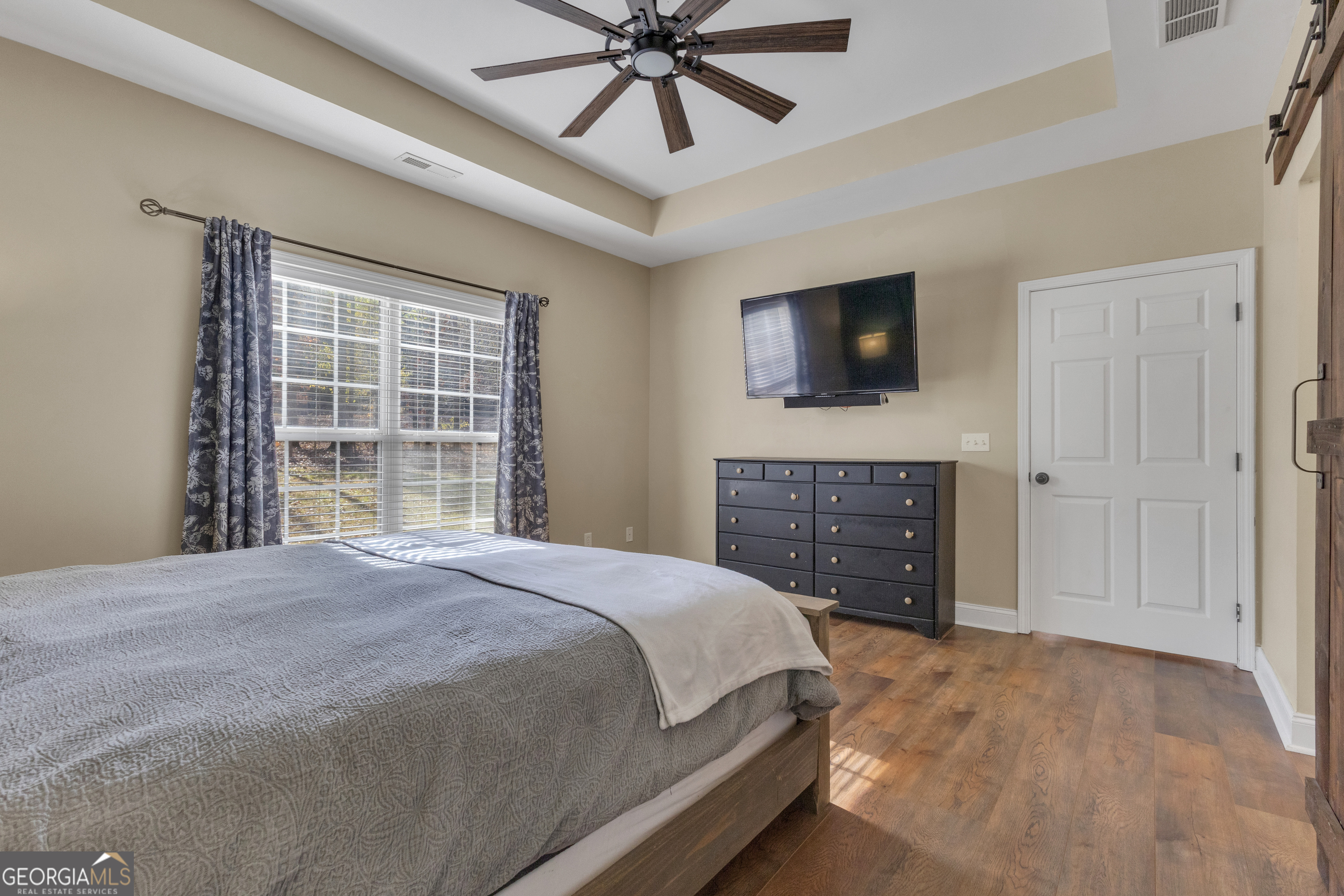 1135 Baptist Camp Road Griffin, GA 30223 - Photo 27 of 54 a bedroom with a bed and a flat screen tv