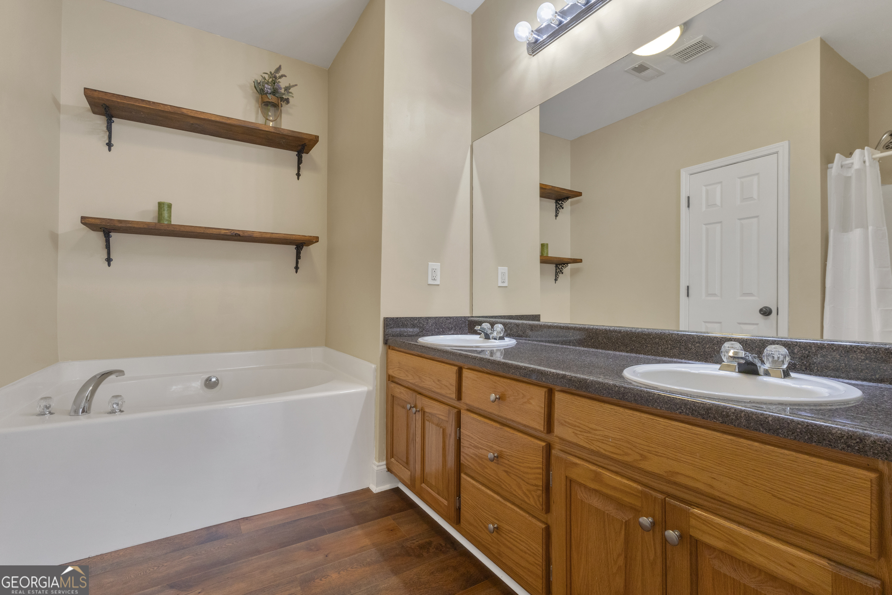 1135 Baptist Camp Road Griffin, GA 30223 - Photo 29 of 54 a bathroom with a tub sink and mirror