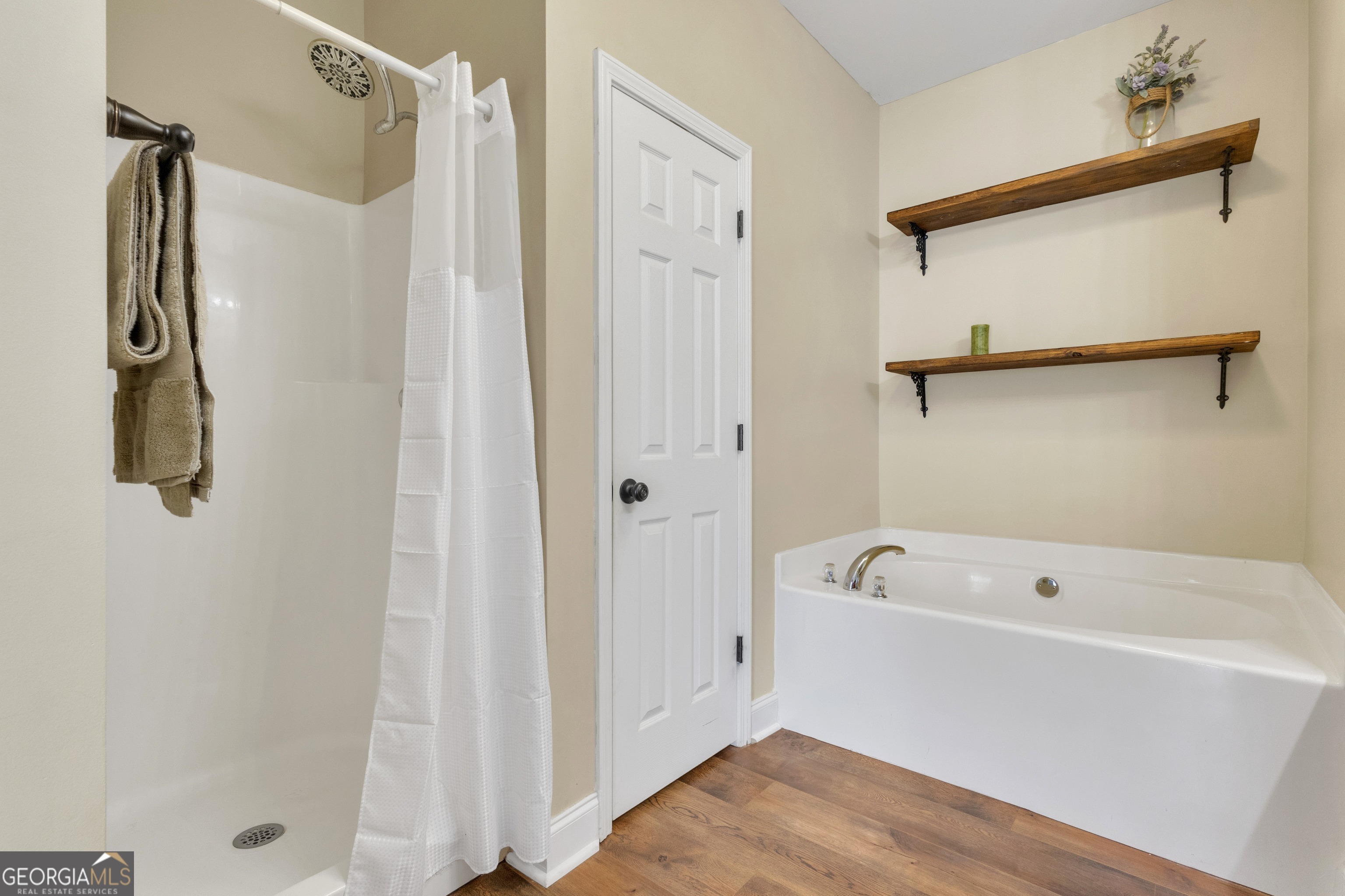 1135 Baptist Camp Road Griffin, GA 30223 - Photo 30 of 54 a bathroom with a tub a sink and a shower