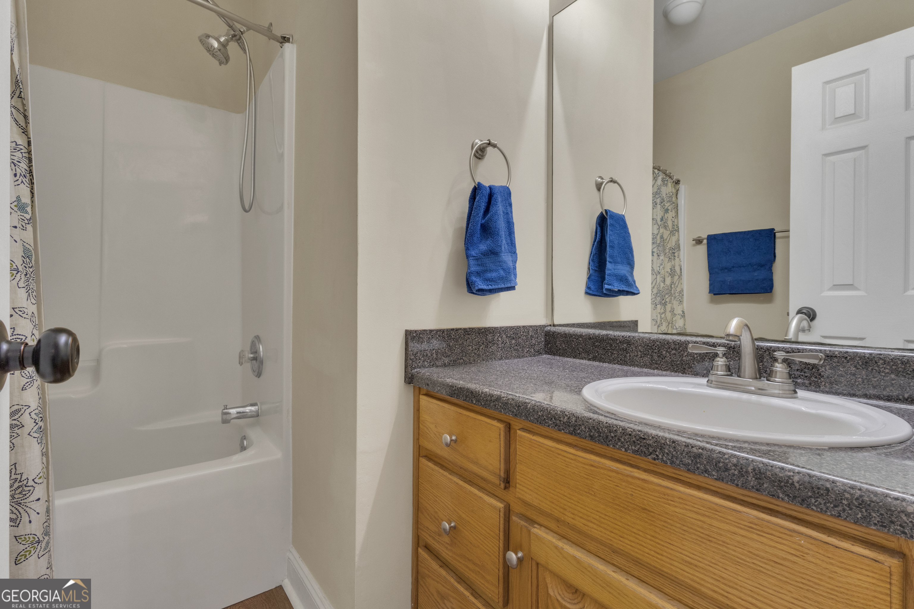 1135 Baptist Camp Road Griffin, GA 30223 - Photo 35 of 54 a bathroom with a granite countertop sink tub and a mirror
