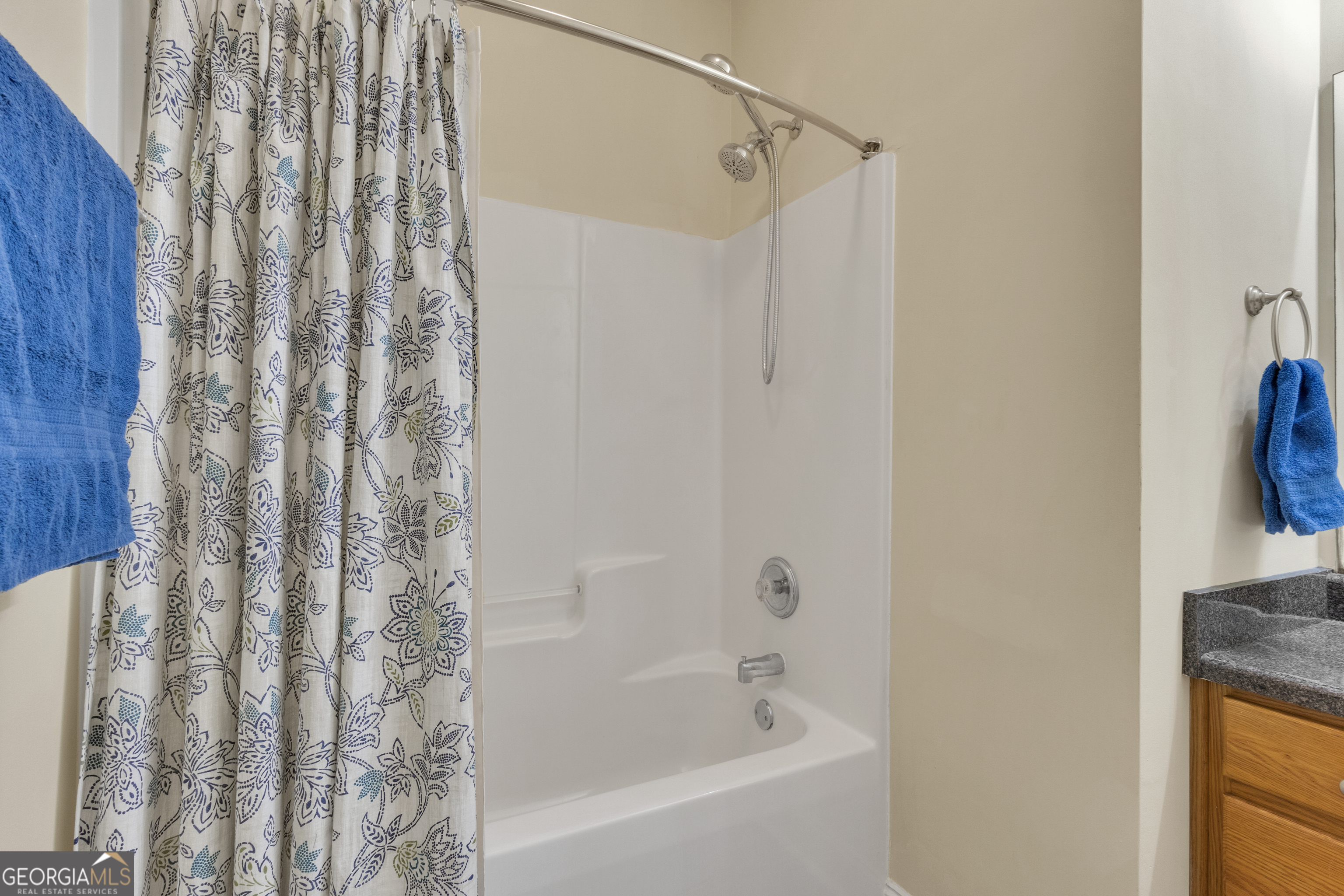 1135 Baptist Camp Road Griffin, GA 30223 - Photo 36 of 54 a bathroom with a shower curtain and a bath tub