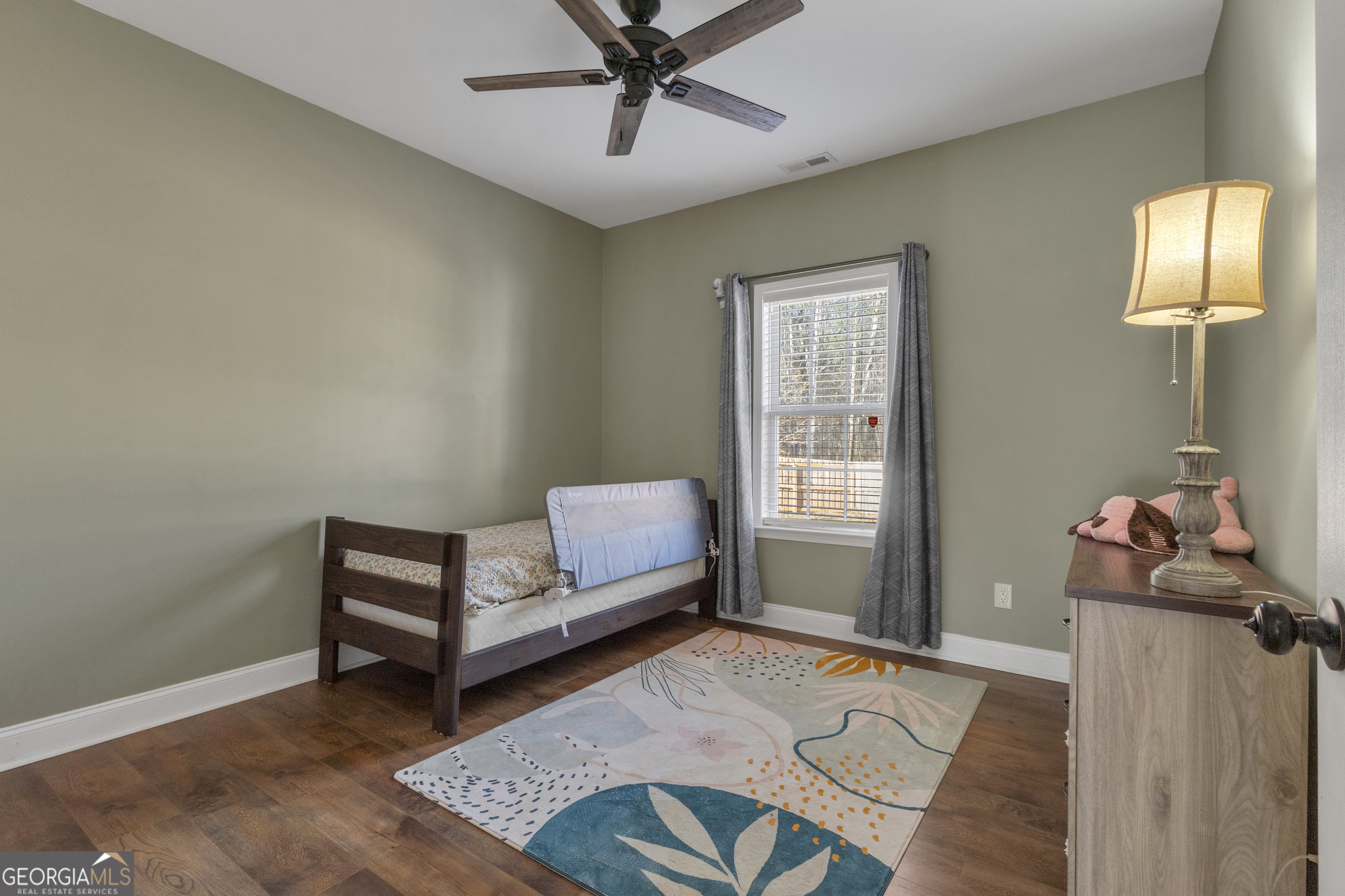 1135 Baptist Camp Road Griffin, GA 30223 - Photo 37 of 54 a bedroom with a bed and wooden floor