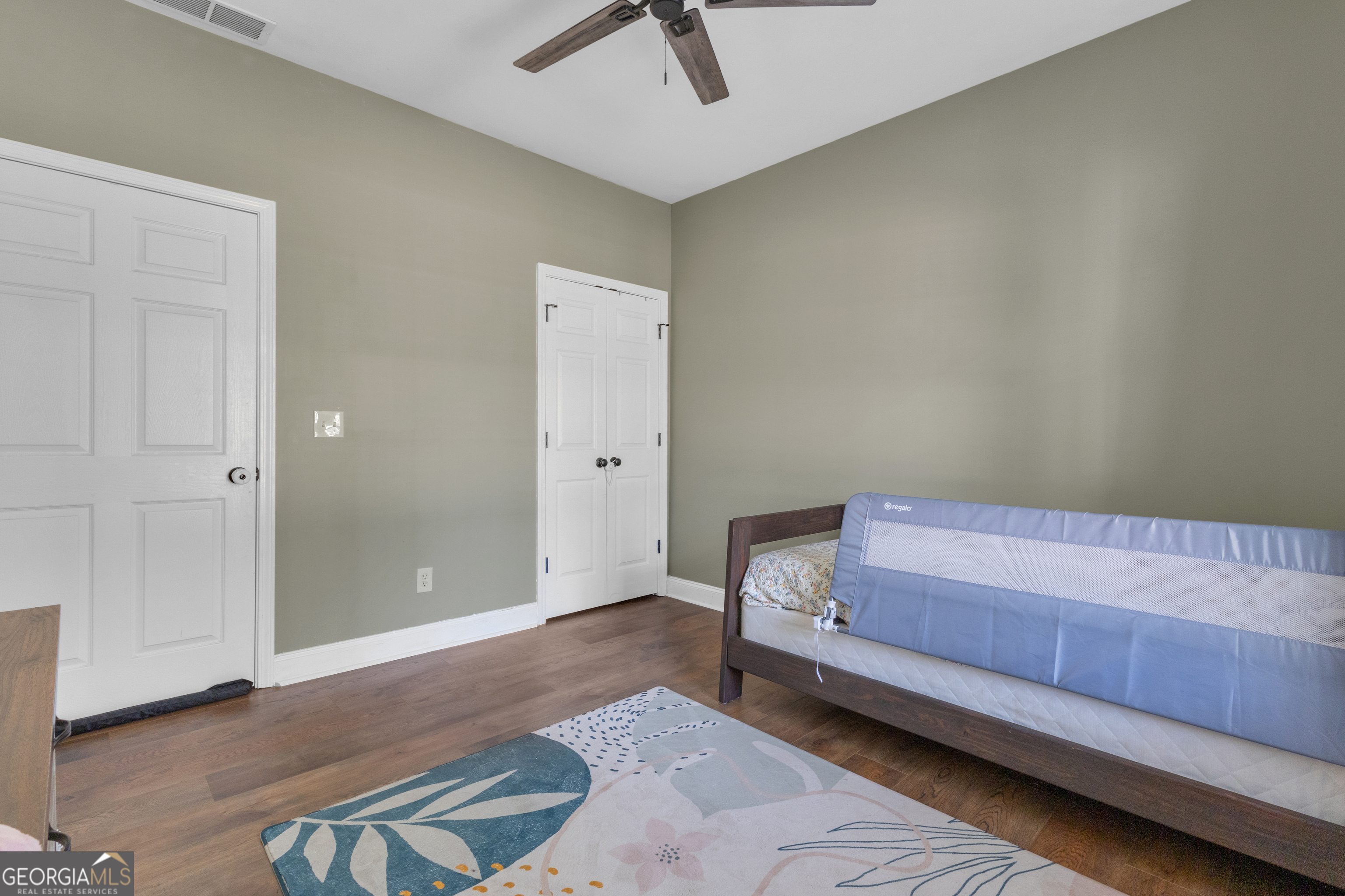 1135 Baptist Camp Road Griffin, GA 30223 - Photo 39 of 54 a bedroom with a bed and a chandelier