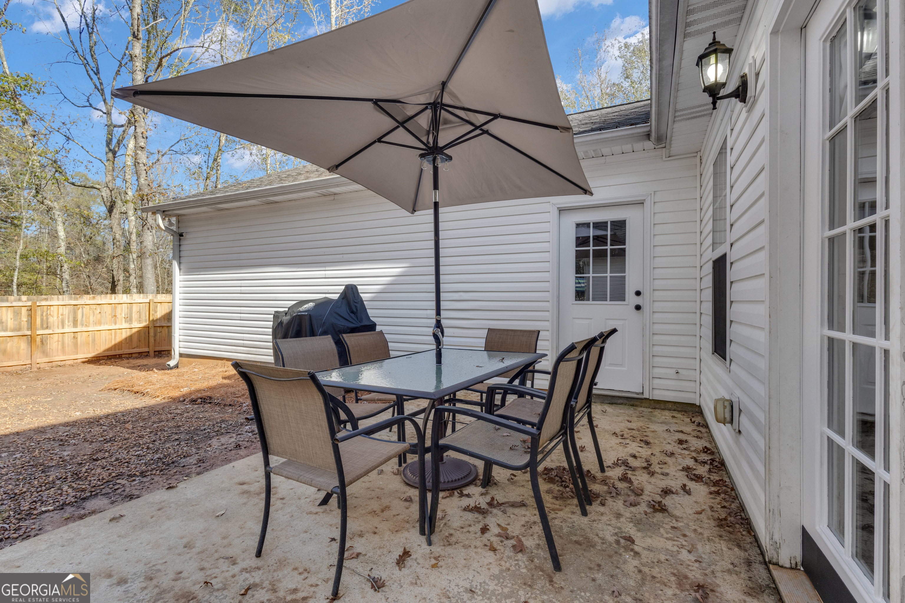 1135 Baptist Camp Road Griffin, GA 30223 - Photo 40 of 54 a patio with table and chairs