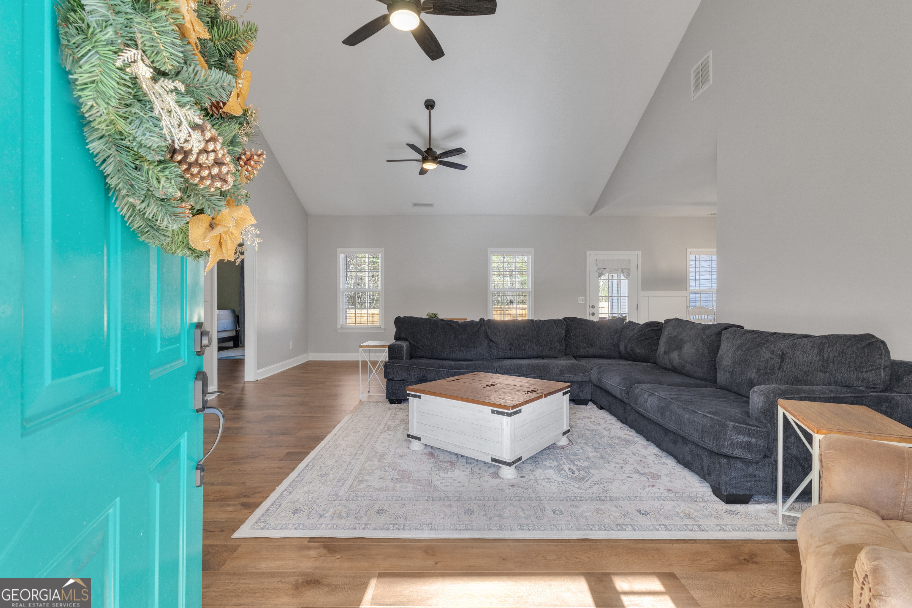 1135 Baptist Camp Road Griffin, GA 30223 - Photo 7 of 54 a living room with furniture and a chandelier