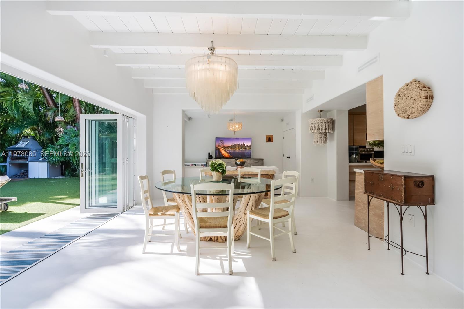 330 Gulf Road Key Biscayne, FL 33149 - Photo 16 of 46 a view of a dining room with furniture and a floor to ceiling window