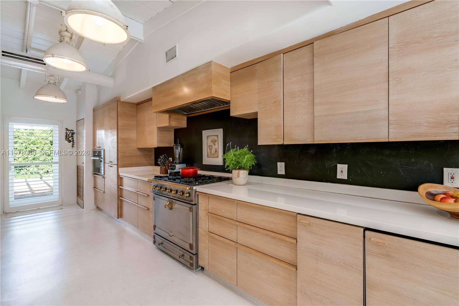 330 Gulf Road Key Biscayne, FL 33149 - Photo 20 of 46 a kitchen with stainless steel appliances granite countertop a stove and a white cabinets