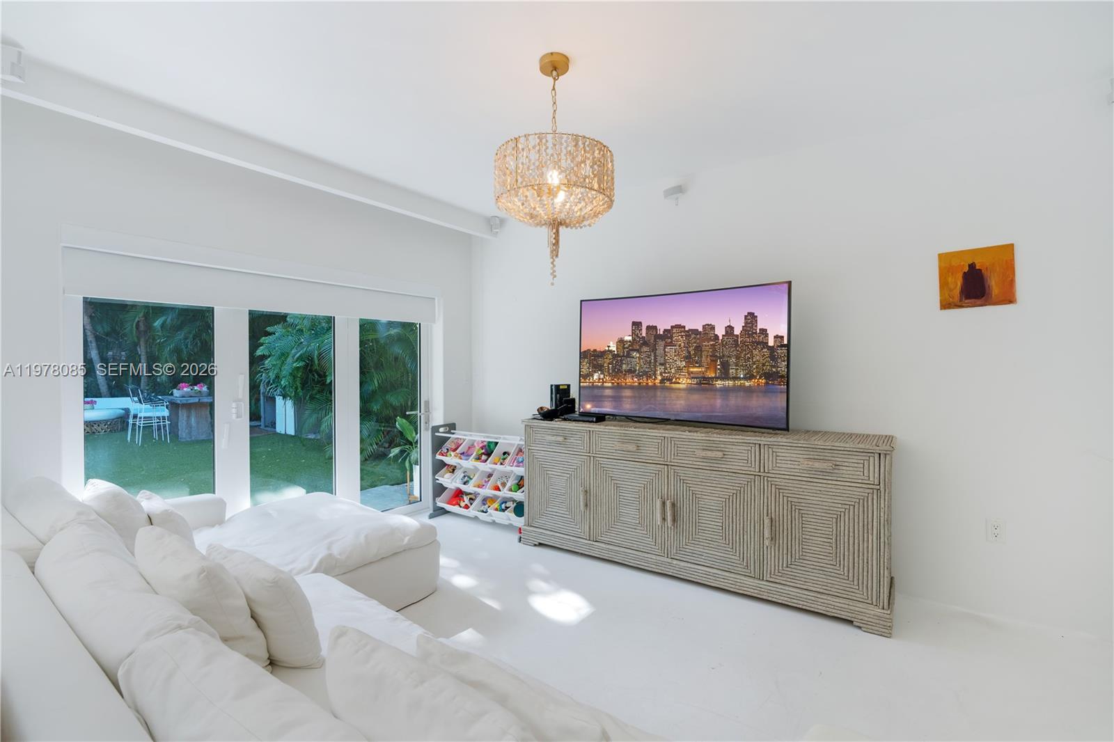 330 Gulf Road Key Biscayne, FL 33149 - Photo 23 of 46 a living room with couch a large window and a flat screen tv