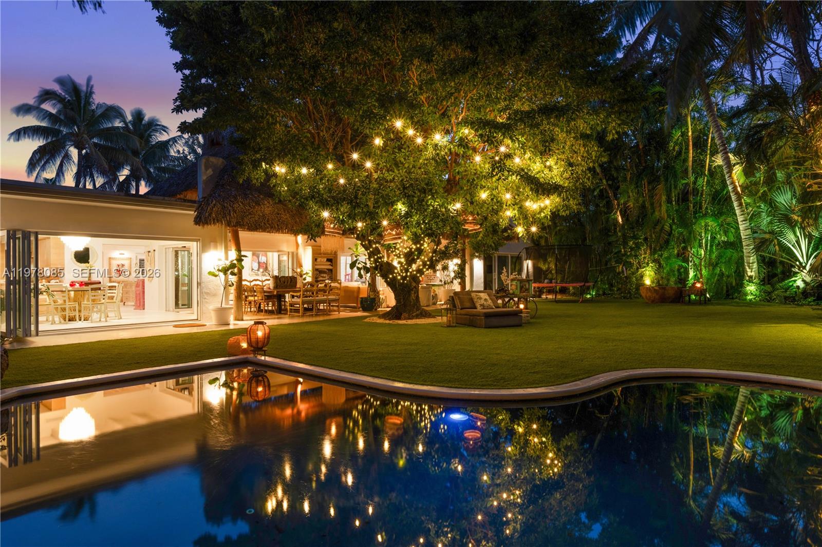 330 Gulf Road Key Biscayne, FL 33149 - Photo 25 of 46 a view of a swimming pool with an outdoor space and seating area