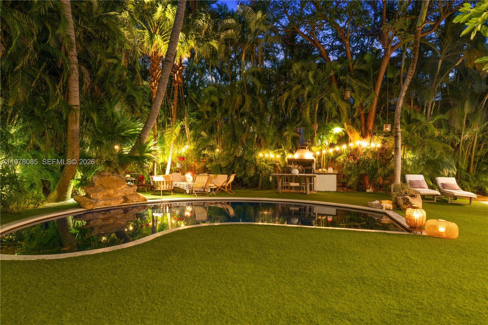 330 Gulf Road Key Biscayne, FL 33149 - Photo 27 of 46 a view of a swimming pool with an outdoor seating and a yard