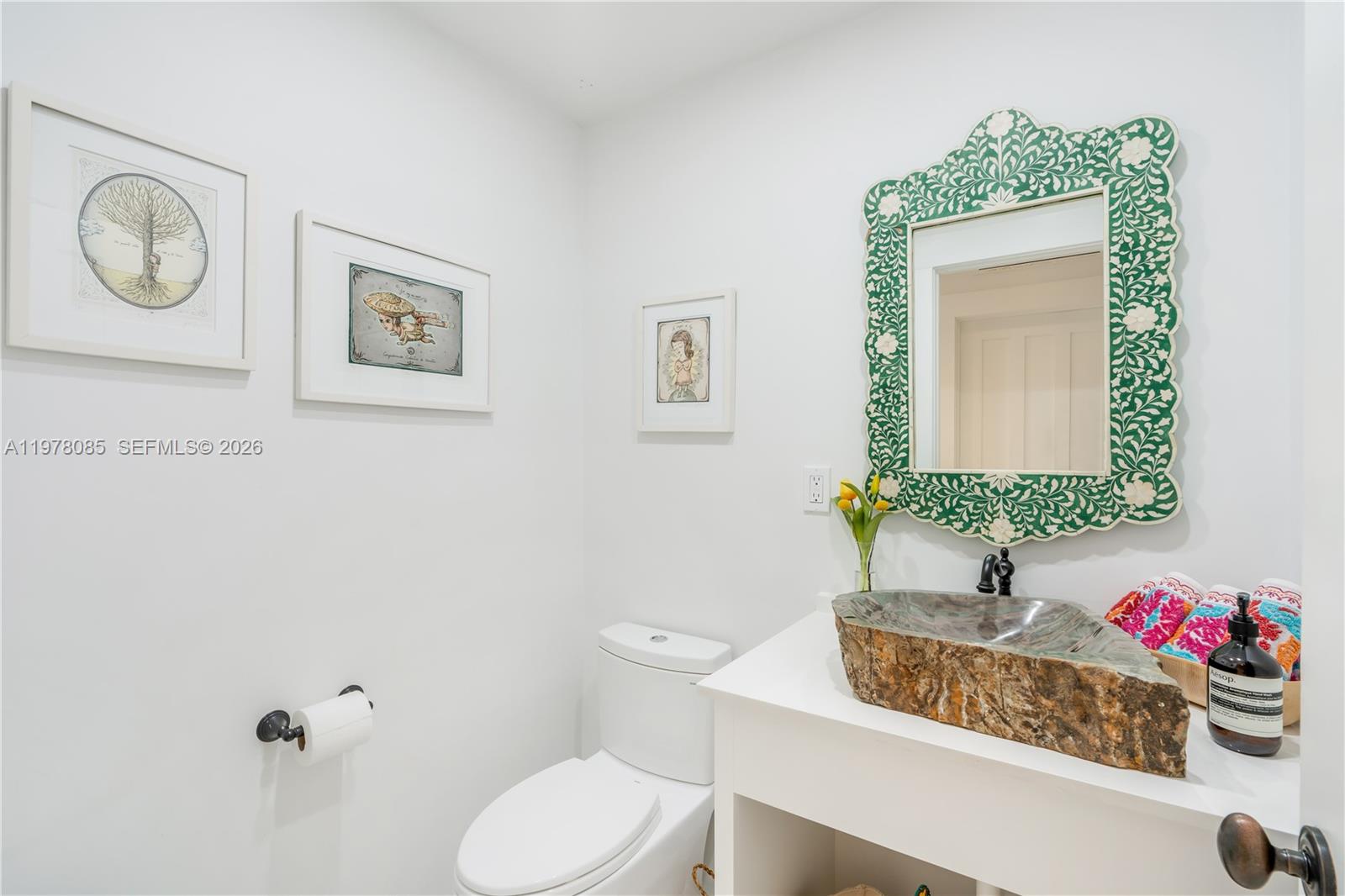 330 Gulf Road Key Biscayne, FL 33149 - Photo 45 of 46 a bathroom with a toilet sink and mirror