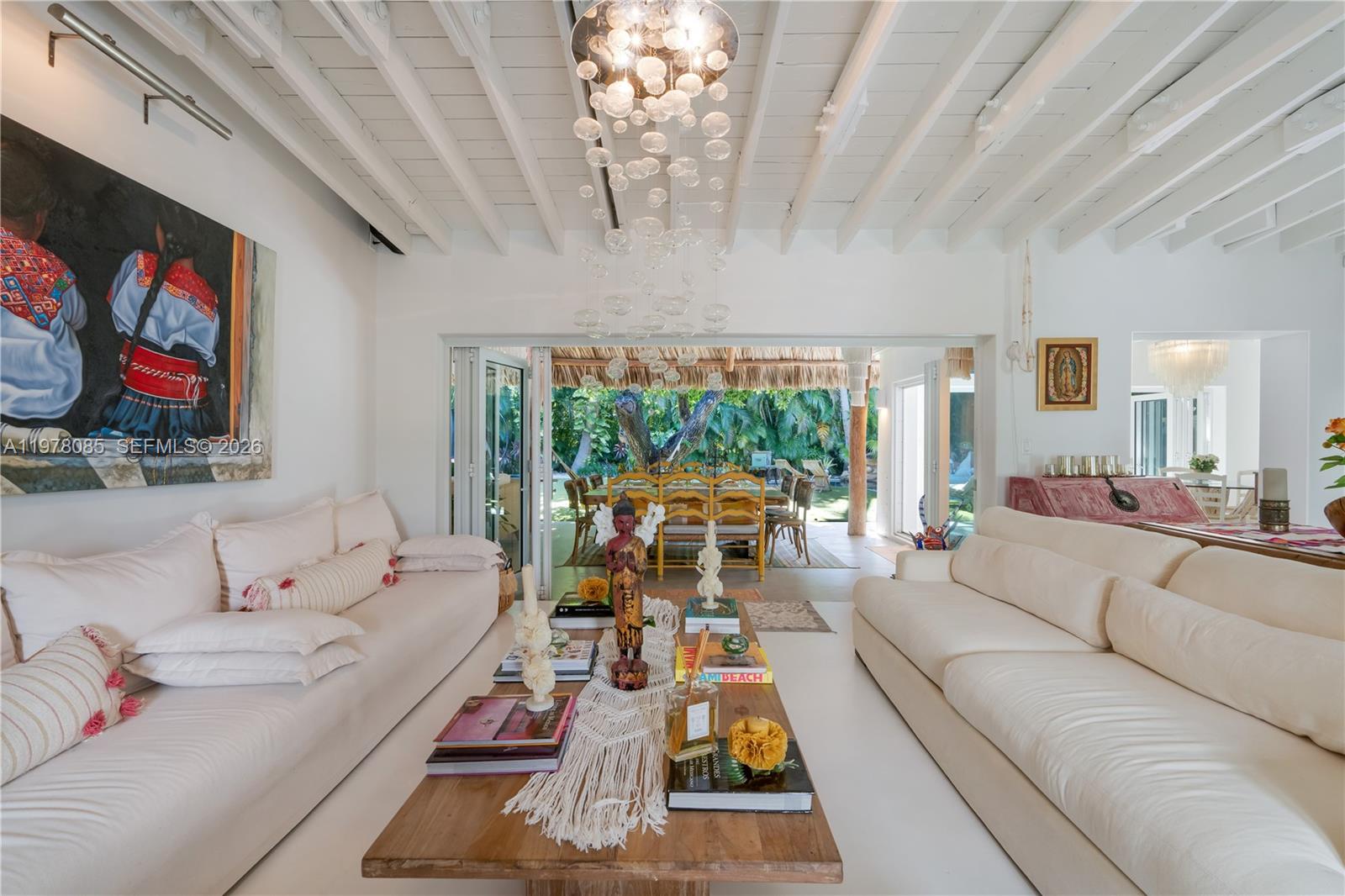 330 Gulf Road Key Biscayne, FL 33149 - Photo 8 of 46 a living room with furniture a chandelier and a large window