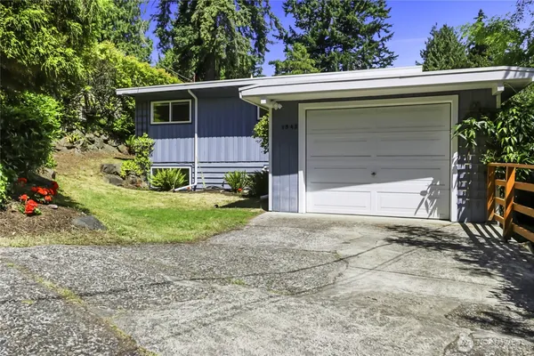 a view of a house with a yard and garage
