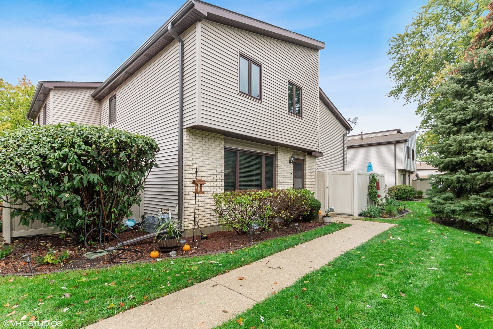 270 East Woodlawn Road, Unit 270 New Lenox, IL 60451 - Photo 1 of 14 a front view of a house with garden