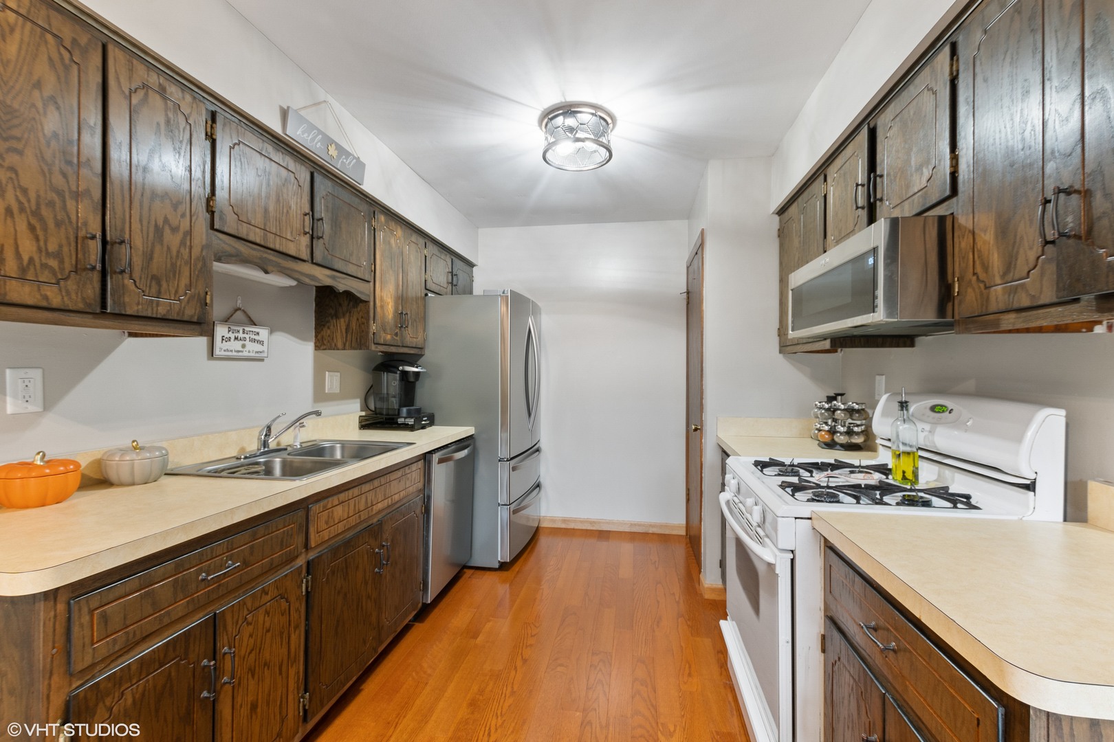 270 East Woodlawn Road, Unit 270 New Lenox, IL 60451 - Photo 4 of 14 a kitchen with stainless steel appliances granite countertop a sink stove and refrigerator