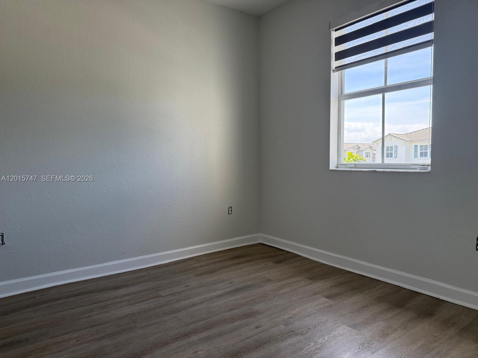 2614 Southeast 13th Street Homestead, FL 33035 - Photo 11 of 19 a view of an empty room with wooden floor and a window