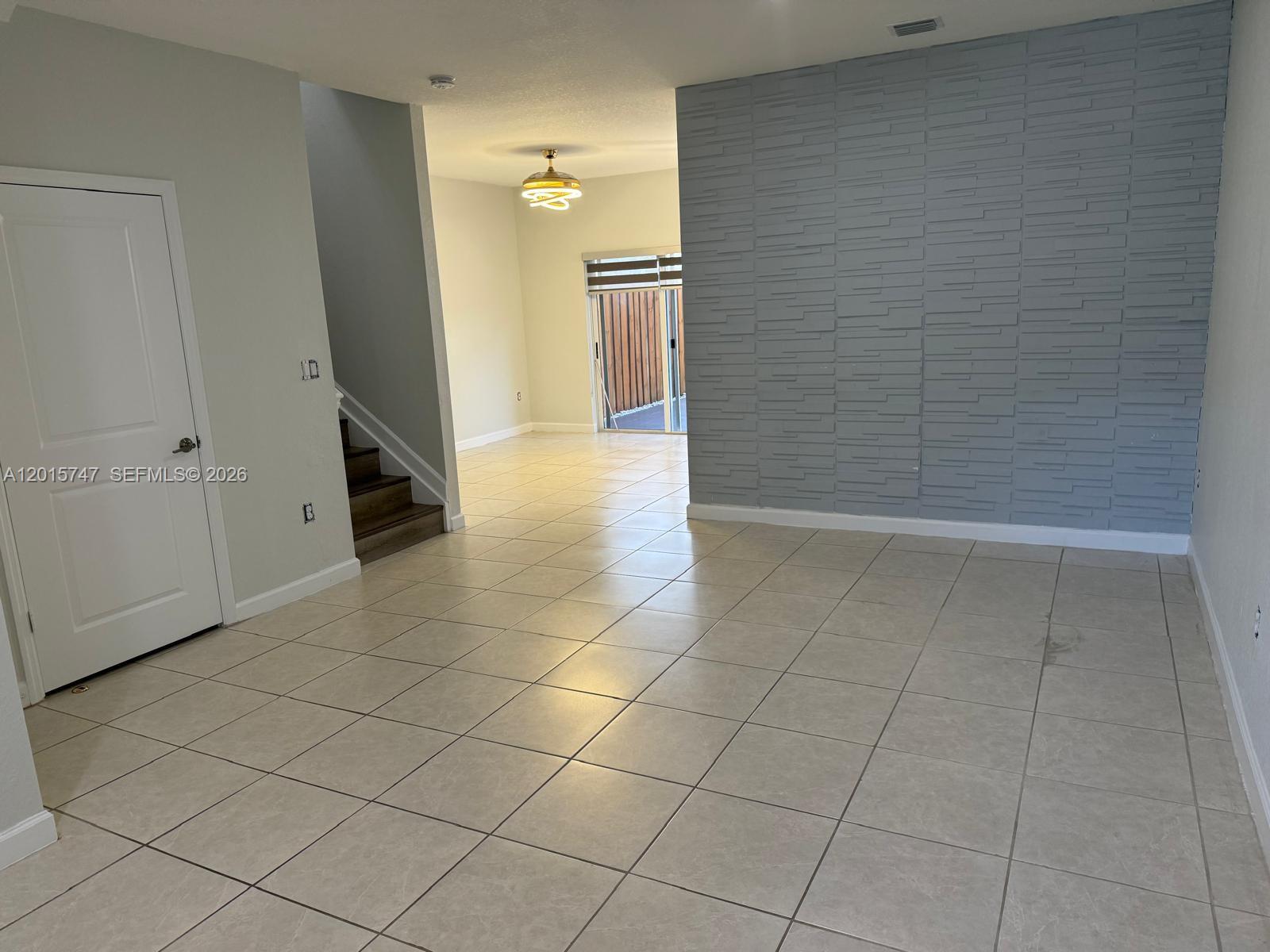 2614 Southeast 13th Street Homestead, FL 33035 - Photo 3 of 19 a view of a livingroom with an empty space and a hallway