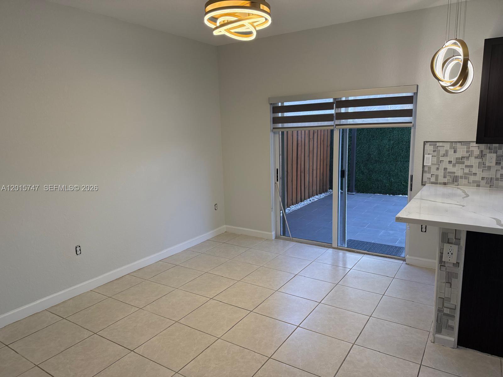 2614 Southeast 13th Street Homestead, FL 33035 - Photo 5 of 19 an empty room with windows