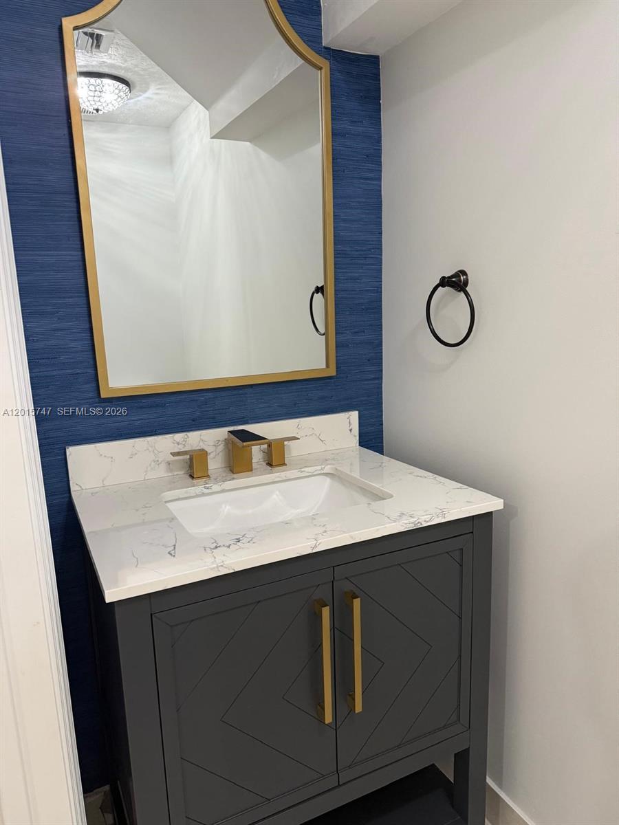 2614 Southeast 13th Street Homestead, FL 33035 - Photo 6 of 19 a bathroom with a sink vanity and a mirror
