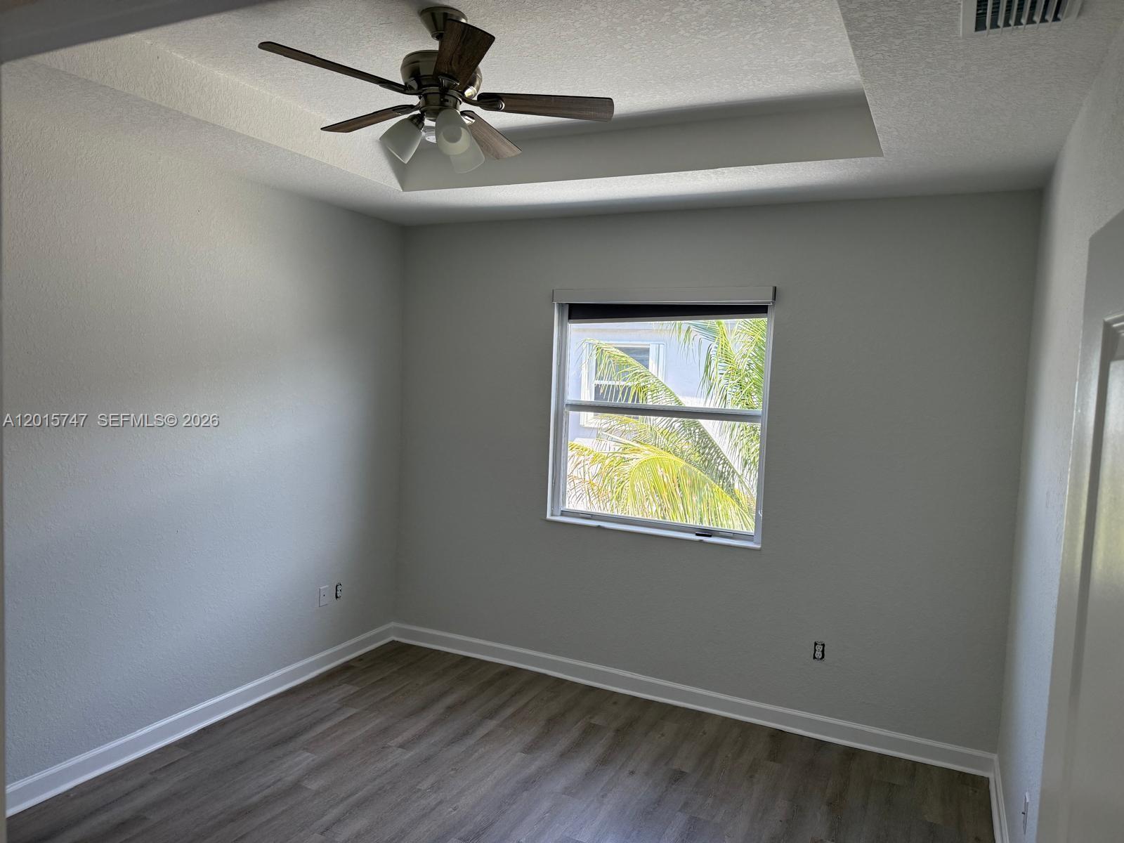 2614 Southeast 13th Street Homestead, FL 33035 - Photo 7 of 19 an empty room with a window and a fan