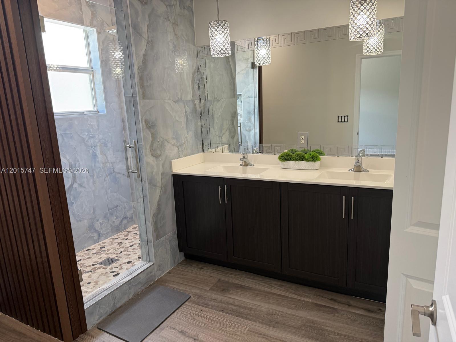 2614 Southeast 13th Street Homestead, FL 33035 - Photo 8 of 19 a bathroom with a sink a mirror and a shower