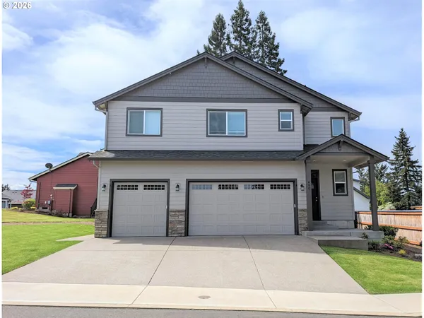 a front view of a house with a yard and garage