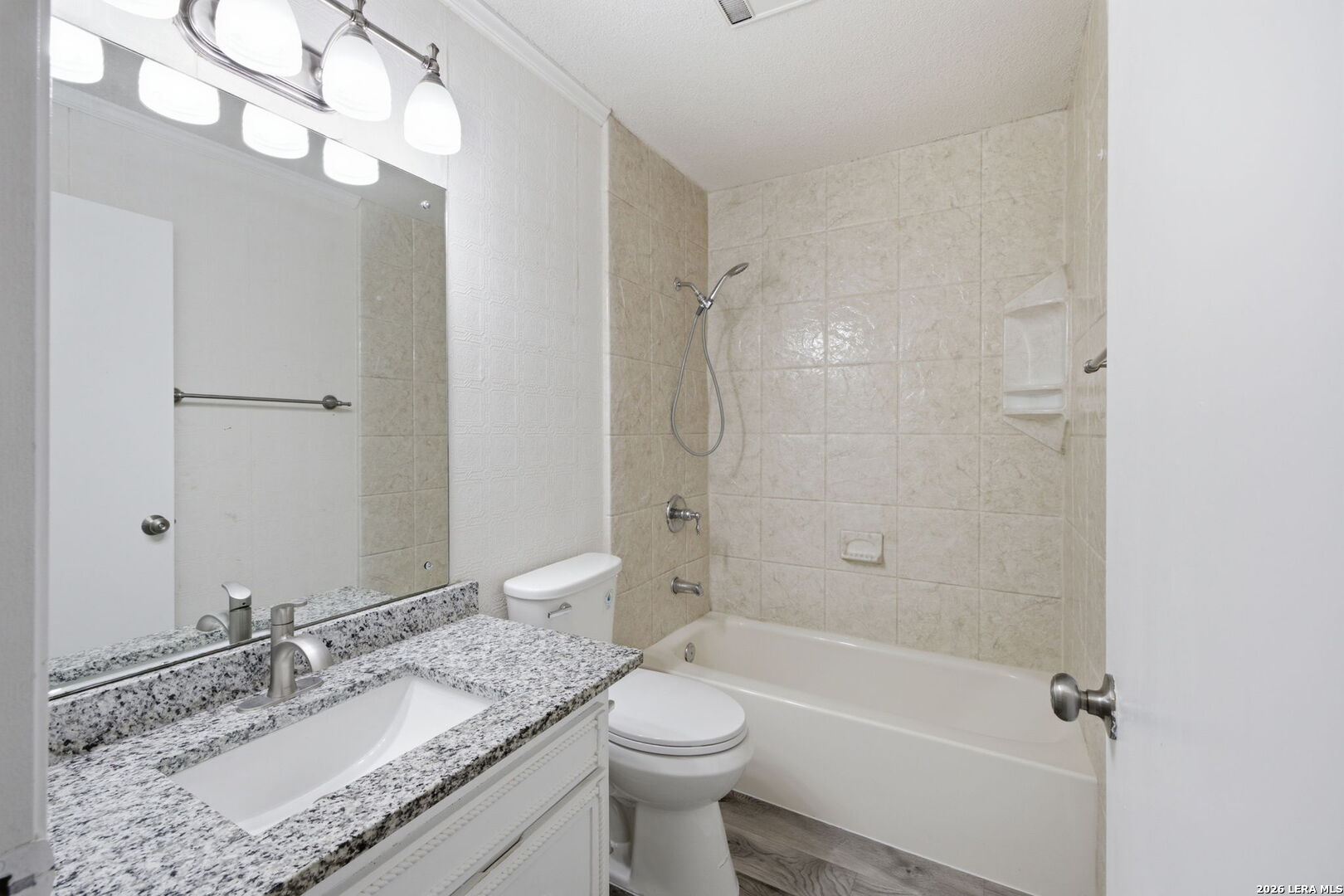 6106 Vance Jackson Road, Unit 15 San Antonio, TX 78230 - Photo 21 of 30 a bathroom with a granite countertop sink a toilet and shower