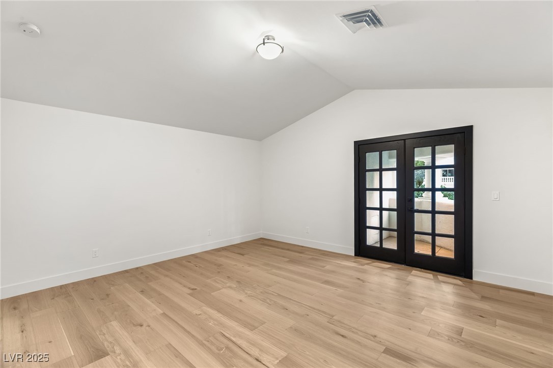 2316 Prometheus Court Henderson, NV 89074 - Photo 48 of 92 Additional living space with visible vents, vaulted ceiling, french doors, and light wood-style flooring