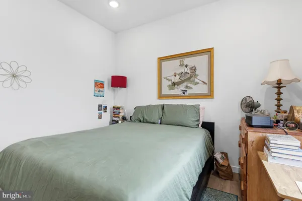a bedroom with a bed and a painting on the wall
