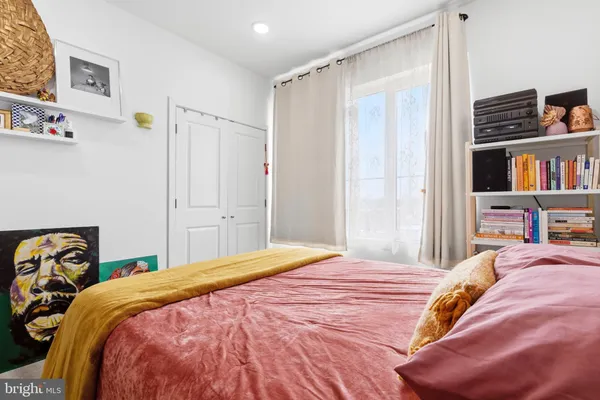 a bedroom with a bed and a closet