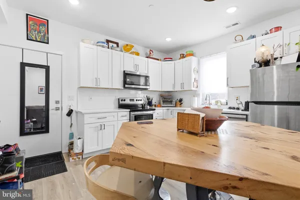 a kitchen with stainless steel appliances granite countertop a refrigerator sink and cabinets