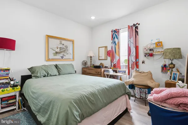 a bedroom with a bed and a painting on the wall