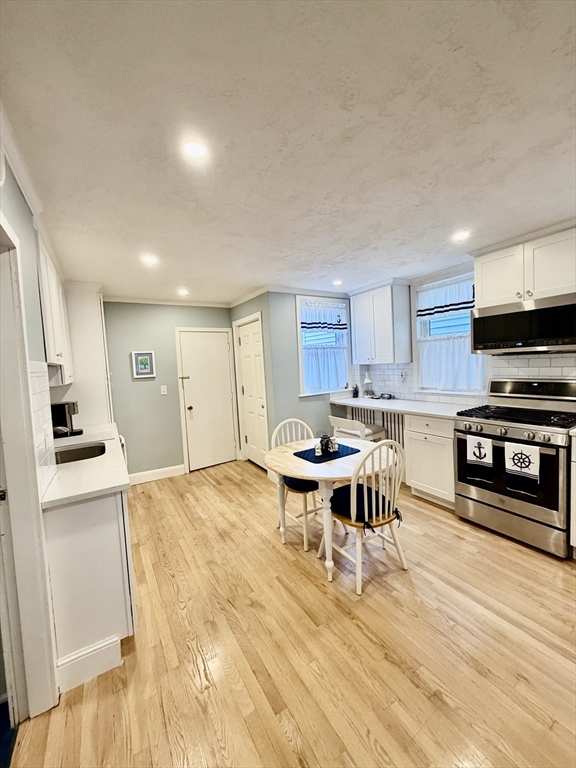 176 M Street, Unit 1 Boston, MA 02127 - Photo 1 of 11 a open kitchen with stainless steel appliances kitchen island granite countertop a sink and cabinets