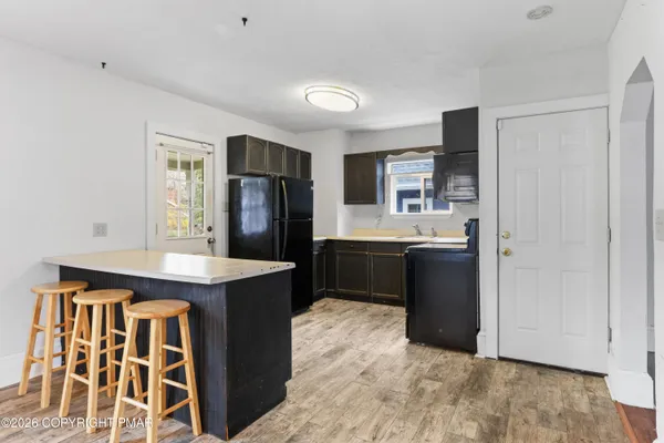 a kitchen with a sink and refrigerator