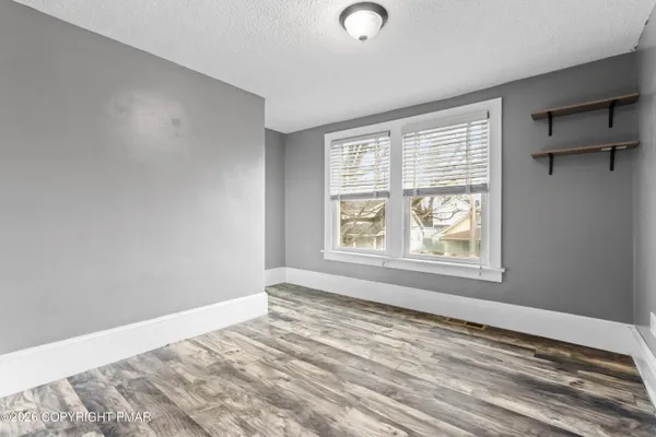 a view of an empty room with a window