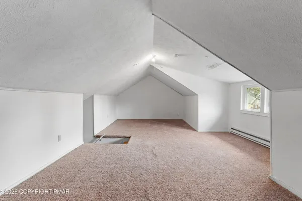 a view of a big room with closet and windows
