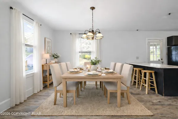 a view of a dining room with furniture window and wooden floor