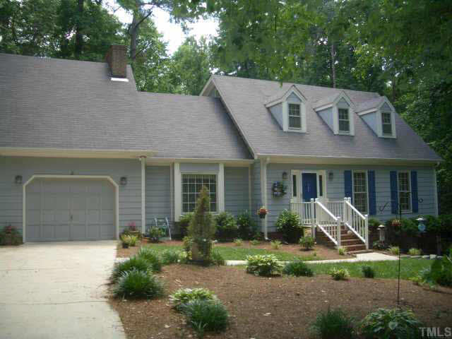 2721 Salisbury Raleigh, NC 27613 - Photo 1 of 10 a view of a house with brick walls and a yard with plants and a large tree